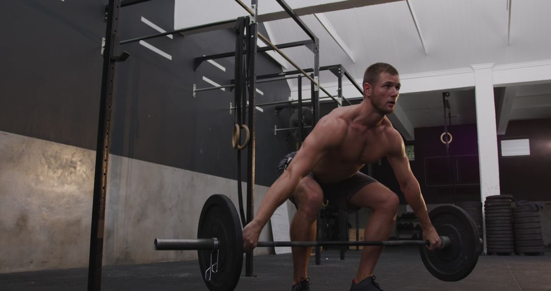 Muscular Man Weightlifting in Gym for Strength Training