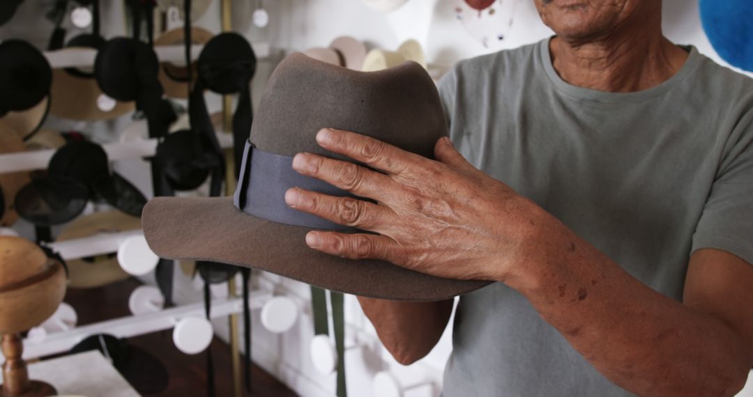 Senior Man Holding Fedora Hat in Hat Shop - Free Images, Stock Photos and Pictures on Pikwizard.com