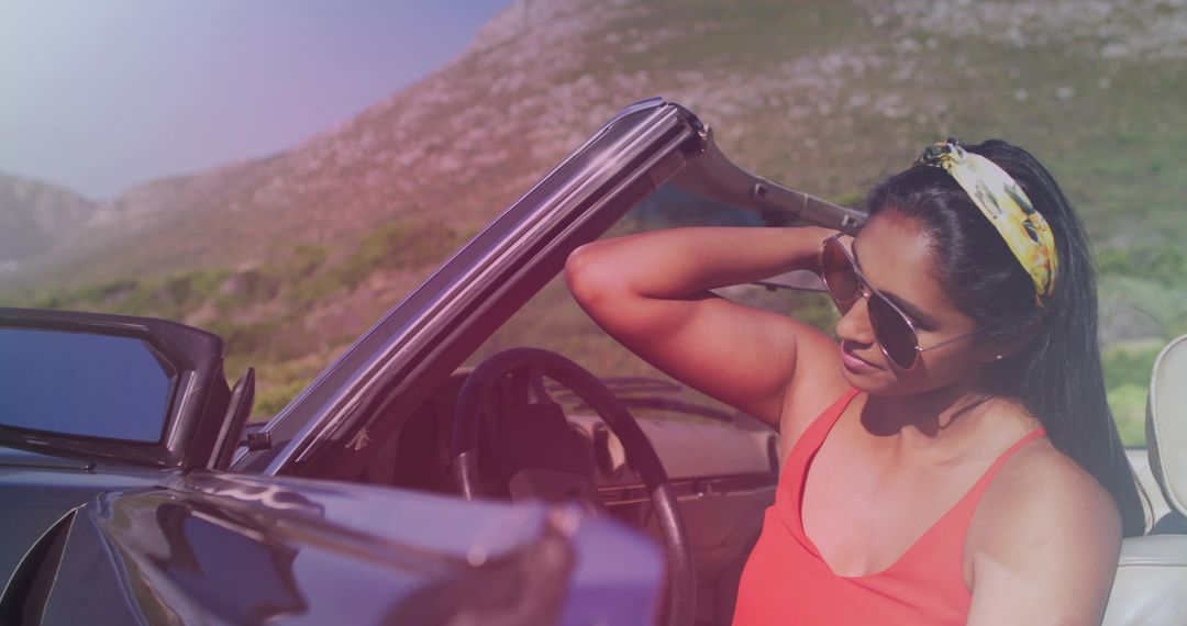 Stylish Woman Relaxing in Convertible on Scenic Mountain Drive