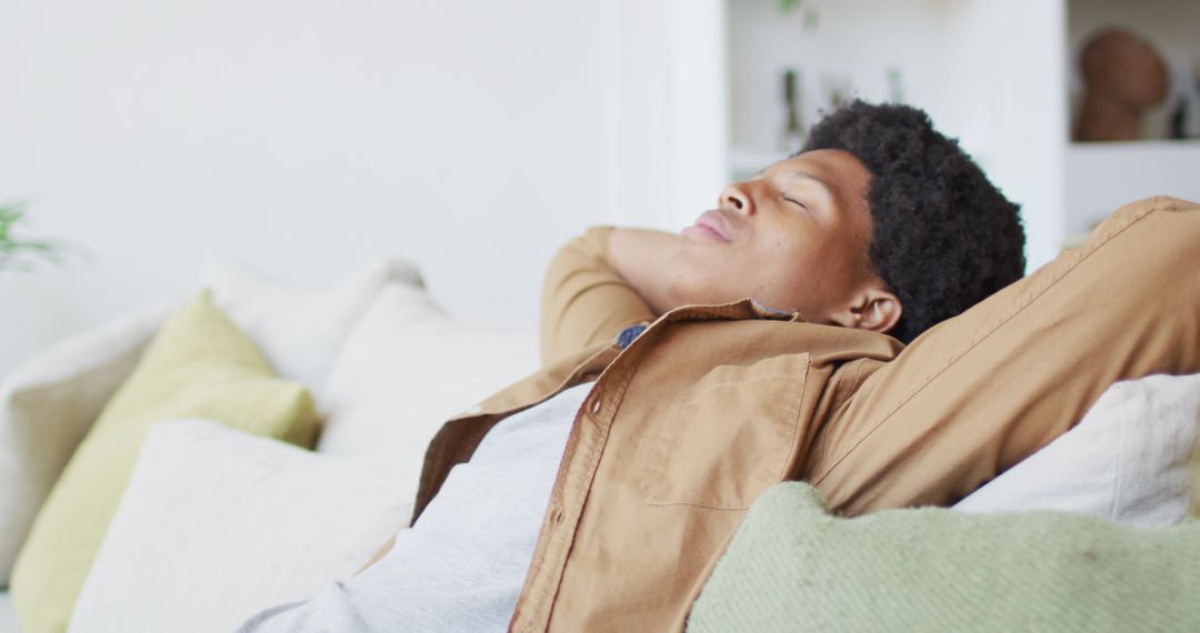 Man Relaxing on Sofa During Leisure Time