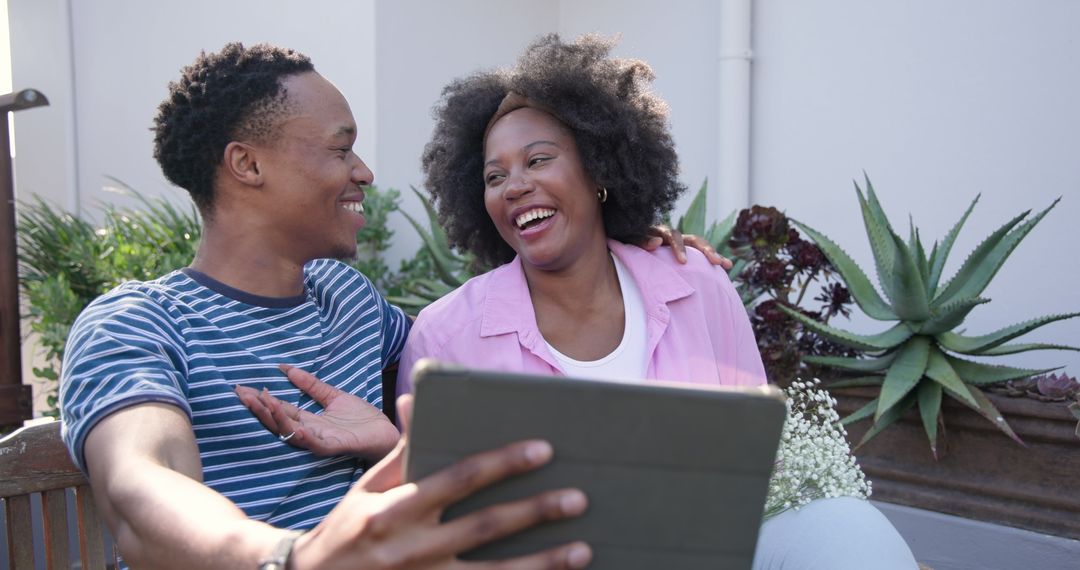 Joyful Couple Taking Selfie with Tablet in Outdoor Setting