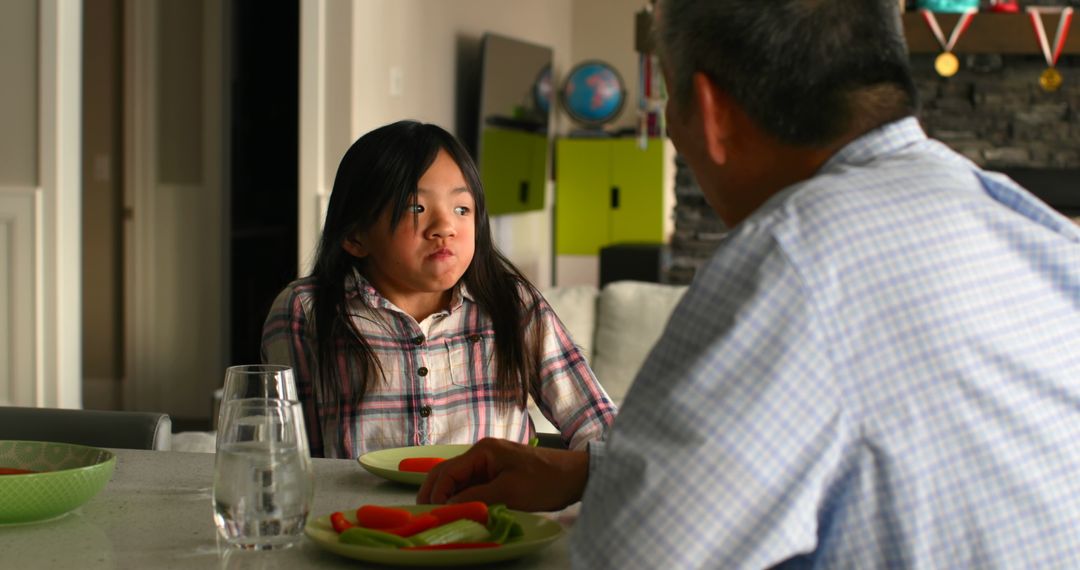 Father and Daughter Sharing a Meal Together in Kitchen - Free Images, Stock Photos and Pictures on Pikwizard.com