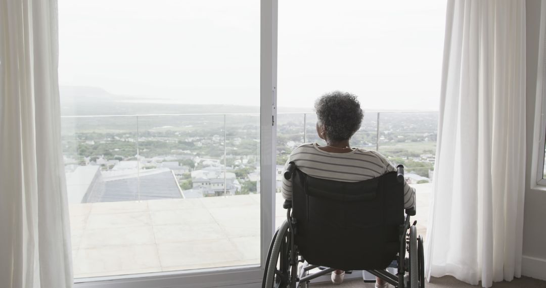 Senior Woman in Wheelchair Looking Out of Large Window at Scenic View - Free Images, Stock Photos and Pictures on Pikwizard.com