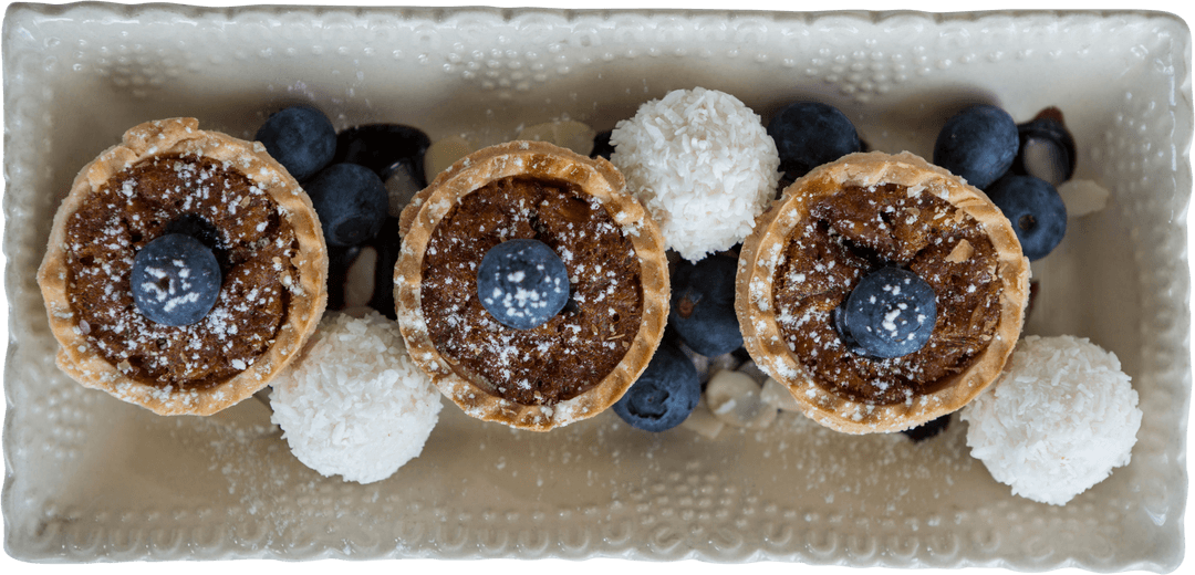Elegant Dessert Arrangement on Transparent Tray with Fresh Berries