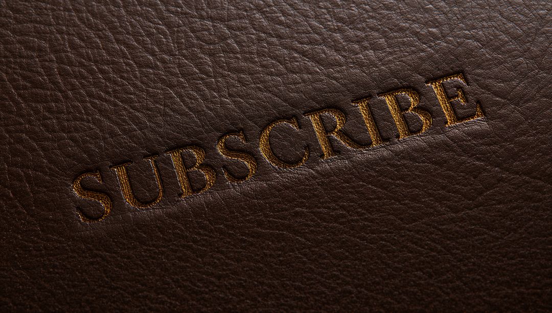 Embossed SUBSCRIBE in Gold Foil on Dark Brown Pebbled Leather