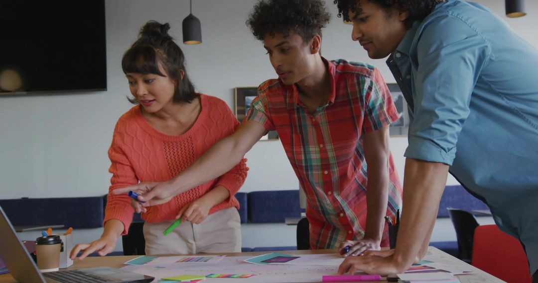 Creative Team Collaborating Over Projects in Modern Office Space