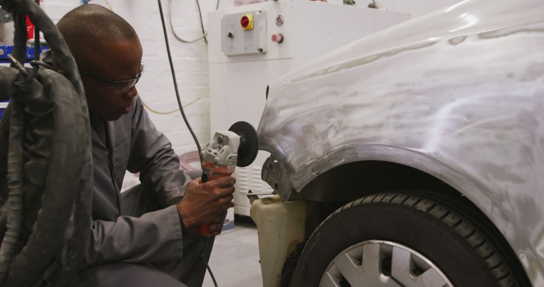 Mechanic Polishing Car Surface in Auto Repair Workshop - Free Images, Stock Photos and Pictures on Pikwizard.com