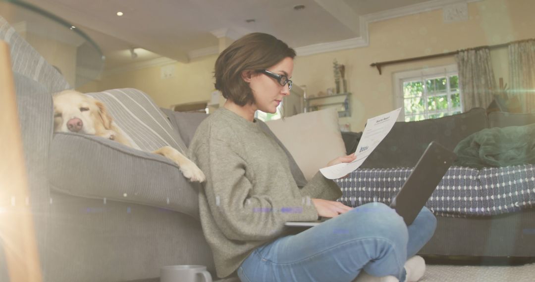 Woman Reviewing Documents at Home with Laptop and Dog on Couch - Free Images, Stock Photos and Pictures on Pikwizard.com