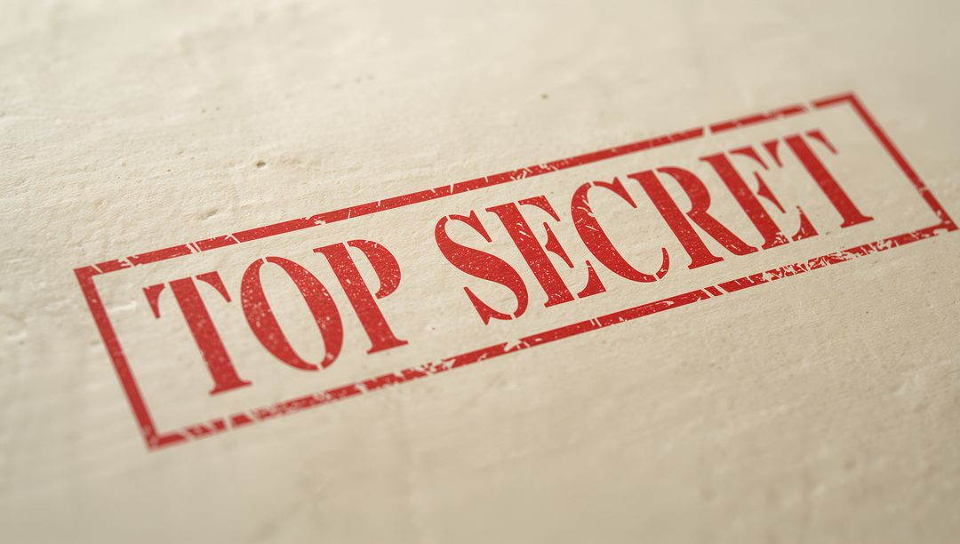 Red TOP SECRET Stamp on Textured Paper Distressed Rectangular Seal Macro