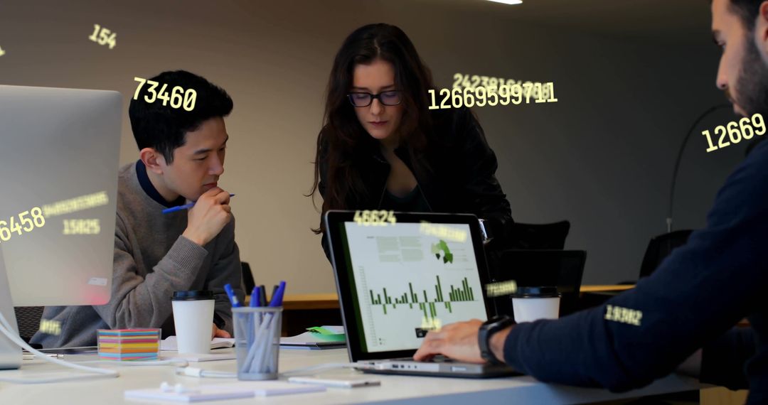 Diverse Colleagues Analyzing Data on Laptops in Modern Office