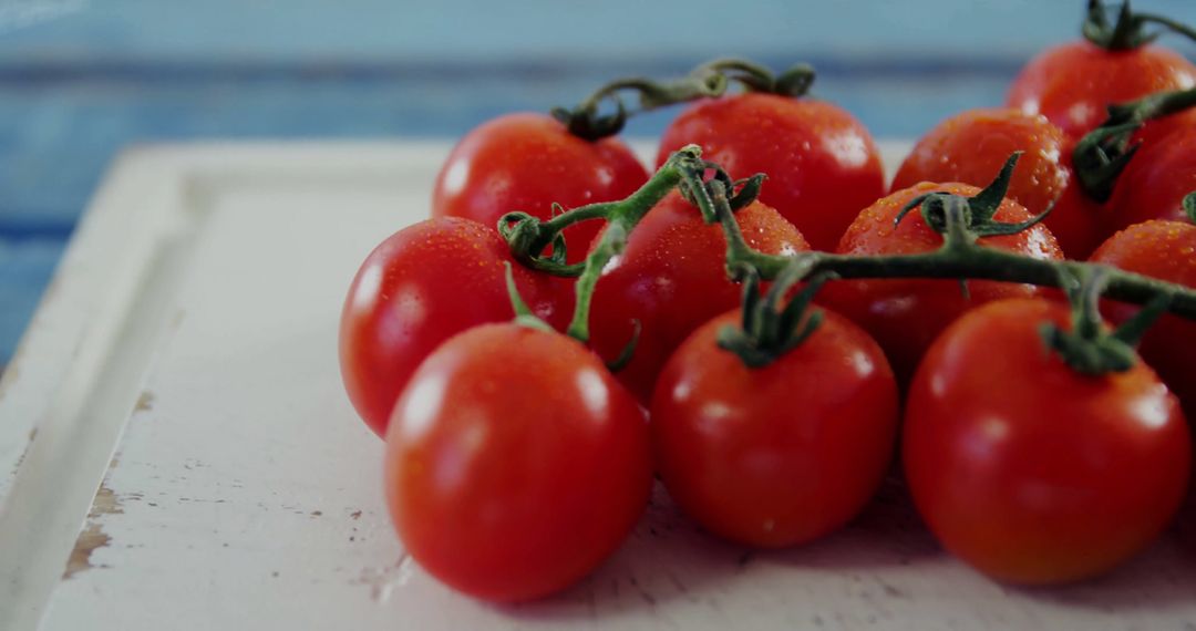 Fresh Organic Red Vine Tomatoes on Rustic White Board