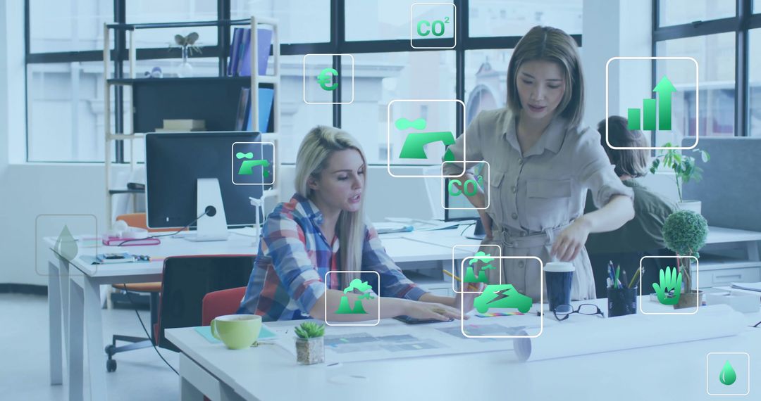 Ecology Icons Over Colleagues in Modern Office Workspace