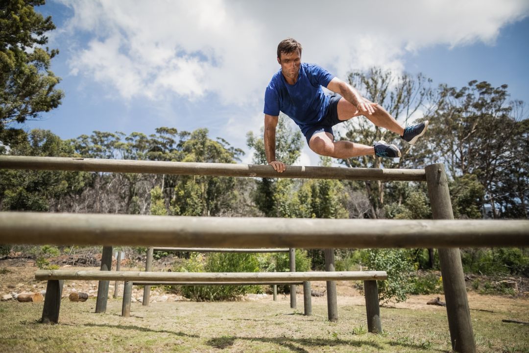 Man Mastering Outdoor Obstacle Challenge for Fitness and Agility