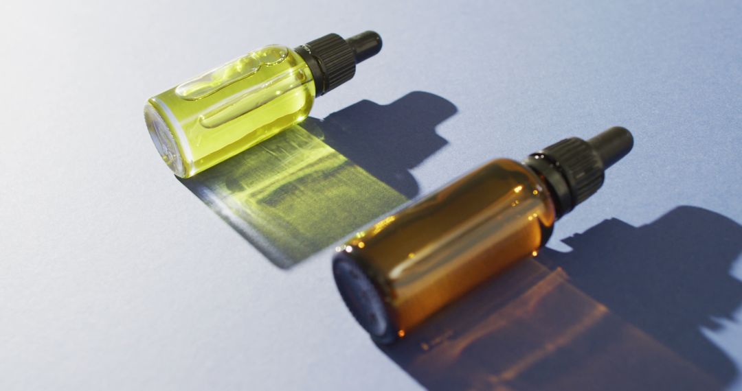 Two Serum Bottles with Droppers on Reflective Surface - Free Images, Stock Photos and Pictures on Pikwizard.com