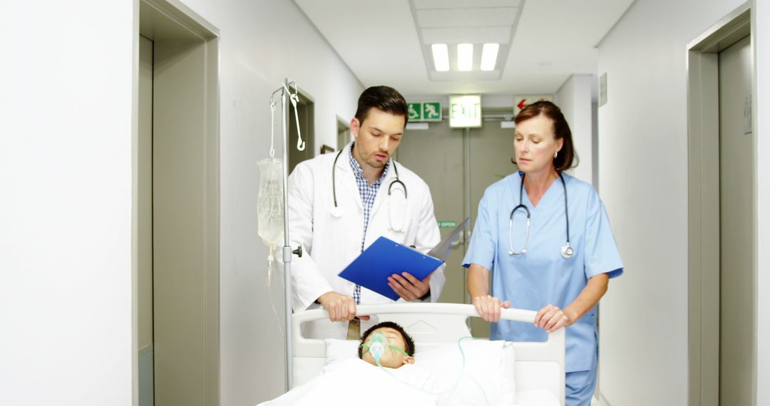 Doctor And Nurse Attending Patient On Hospital Gurney In Hallway - Free Images, Stock Photos and Pictures on Pikwizard.com