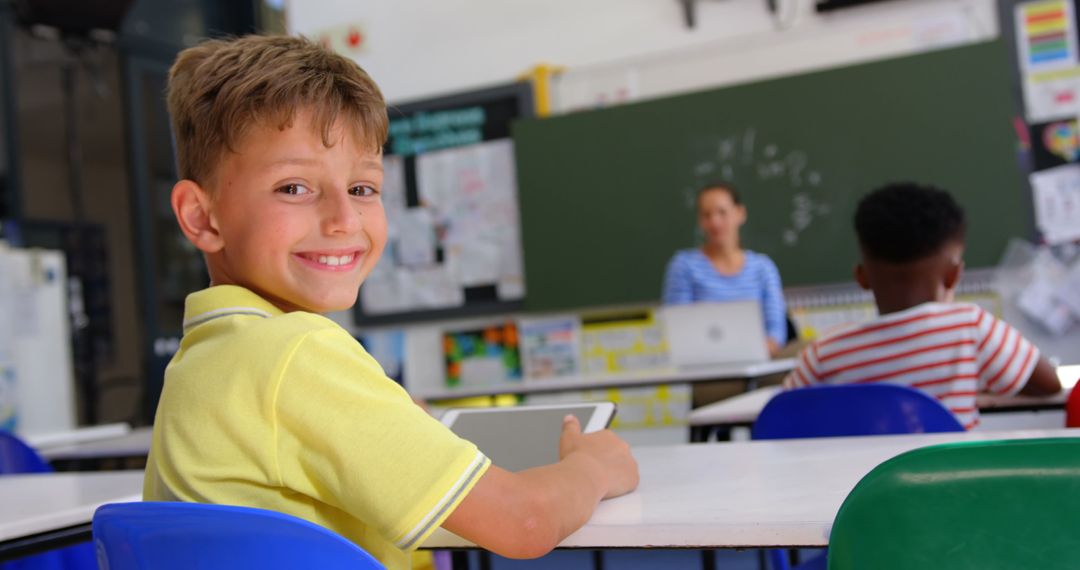 Smiling Schoolboy Looking Back in Classroom During Lesson