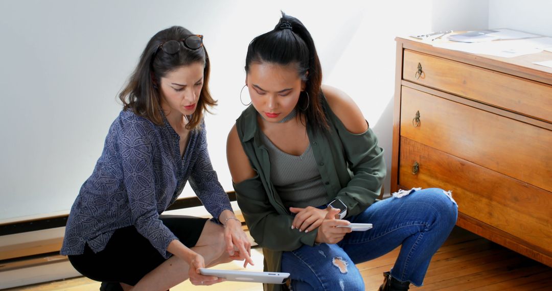 Focused Diverse Female Architects Collaborating in Casual Office