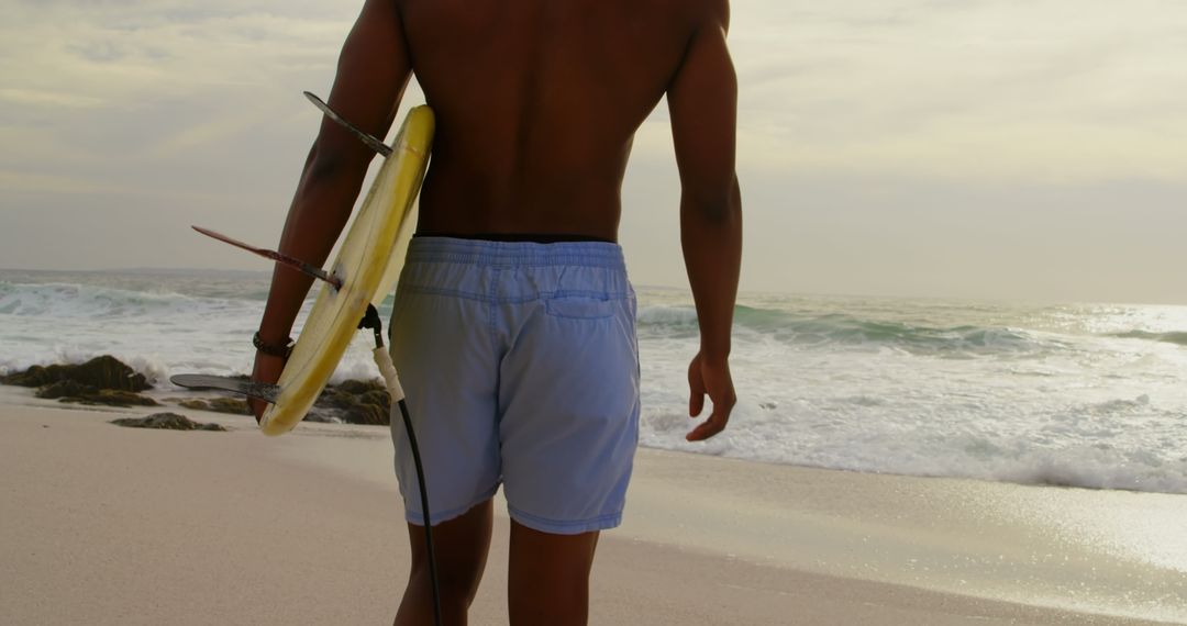 Surfer Walking with Board Towards Sea