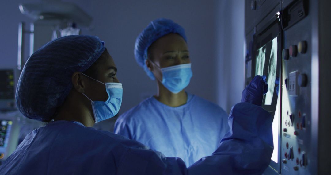 Female Surgeons Analyzing X-rays Before Surgery in Operating Room - Free Images, Stock Photos and Pictures on Pikwizard.com