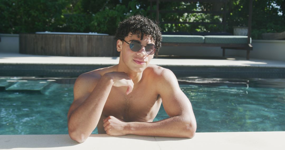 Young Man Relaxing in Outdoor Swimming Pool on a Sunny Day - Free Images, Stock Photos and Pictures on Pikwizard.com