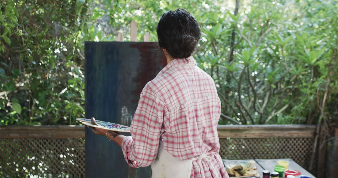 Woman Painting Outdoors Back View in Springtime Garden - Free Images, Stock Photos and Pictures on Pikwizard.com