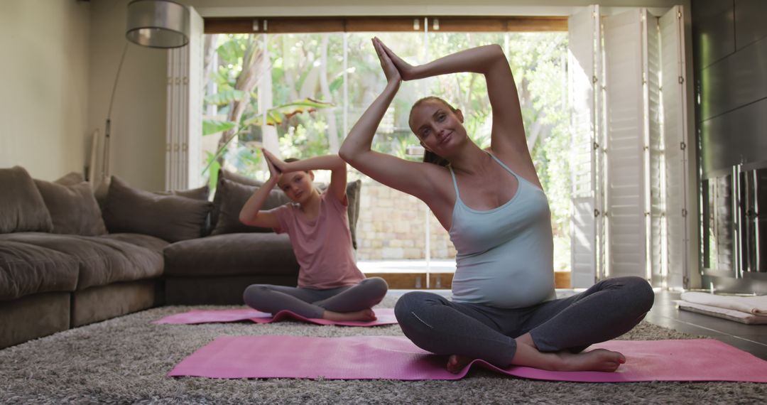 Two Pregnant Women Practicing Yoga in Living Room with Natural Light - Free Images, Stock Photos and Pictures on Pikwizard.com