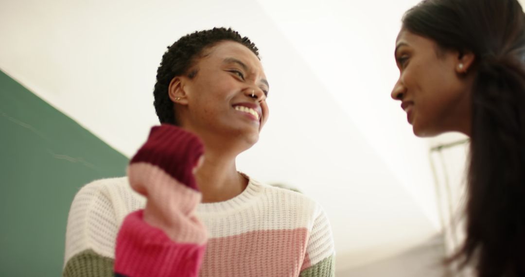 Diverse Women Bonding and Smiling in Educational Setting