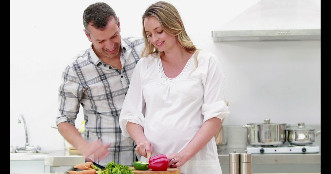 Pregnant Couple Preparing Healthy Meal in Modern Kitchen - Free Images, Stock Photos and Pictures on Pikwizard.com