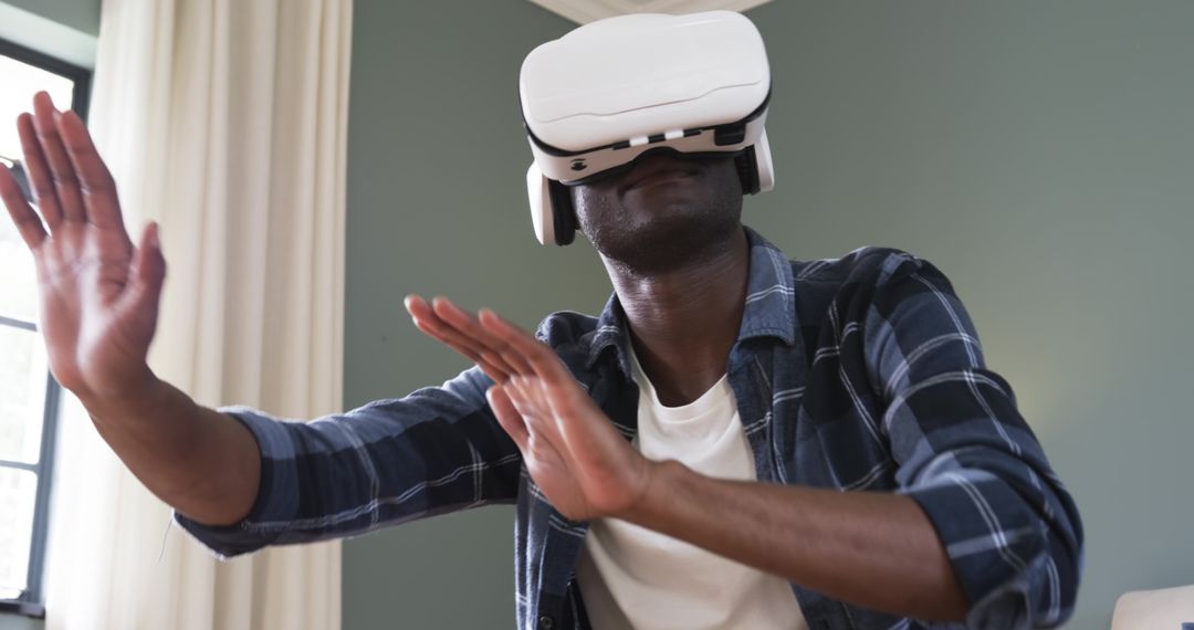 Man Experiencing Virtual World with VR Headset in Casual Home Environment
