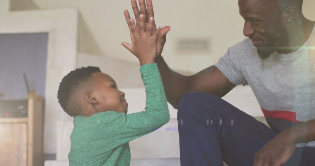 Father and Son Bonding with a High Five at Home