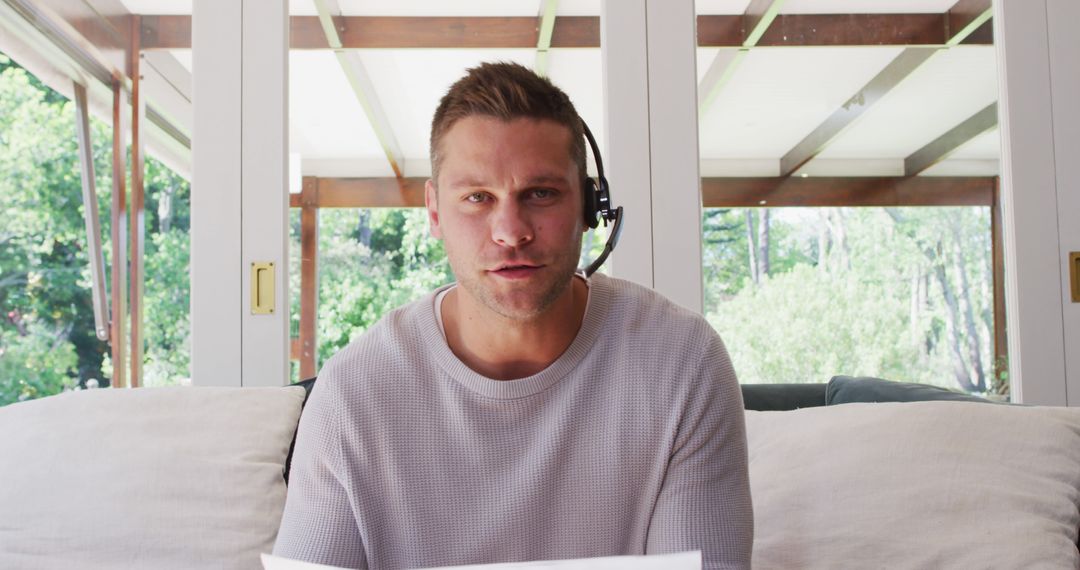 Man Working Remotely with Headset in Home Office - Free Images, Stock Photos and Pictures on Pikwizard.com