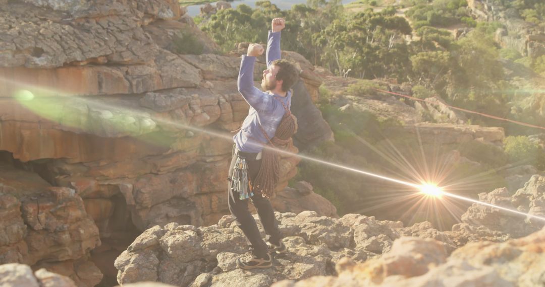 Caucasian Man Standing on Rocky Cliff Celebrating Achievement