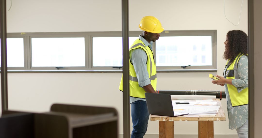 Architects Discussing Building Plans on Construction Site - Free Images, Stock Photos and Pictures on Pikwizard.com