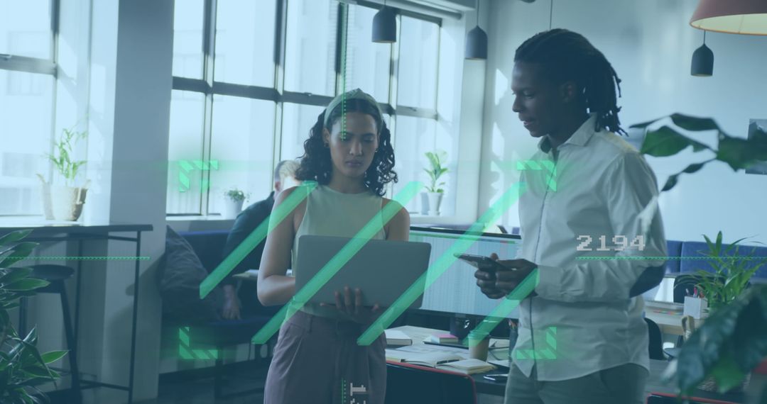 Diverse Professionals Collaborating with Technology in Modern Open Office