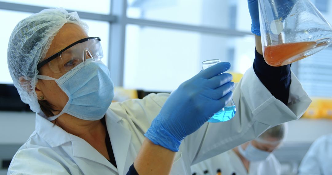 Female Scientist Conducting Laboratory Experiment With Liquids - Free Images, Stock Photos and Pictures on Pikwizard.com