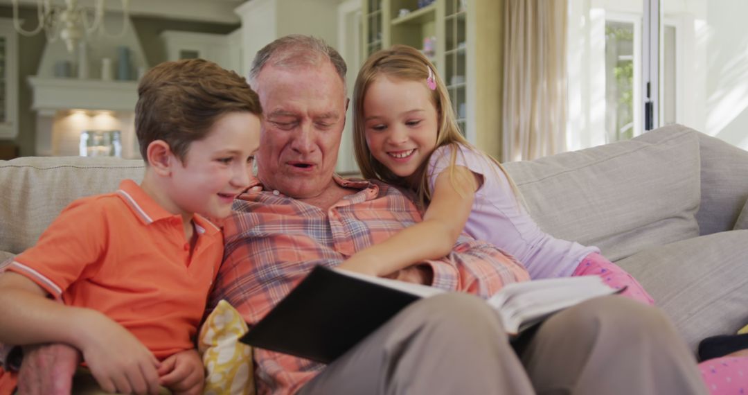 Grandfather Reading to Happy Grandchildren on Sofa - Free Images, Stock Photos and Pictures on Pikwizard.com