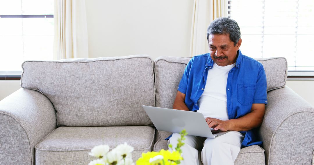 Senior Man Using Laptop at Home on Couch - Free Images, Stock Photos and Pictures on Pikwizard.com