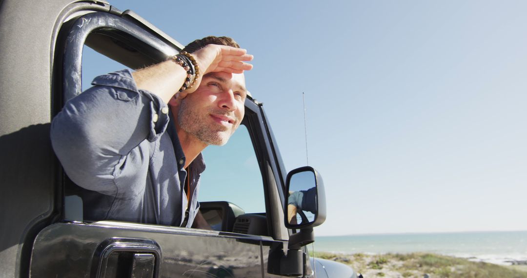 Man enjoying scenic coastal road trip on a sunny day - Free Images, Stock Photos and Pictures on Pikwizard.com