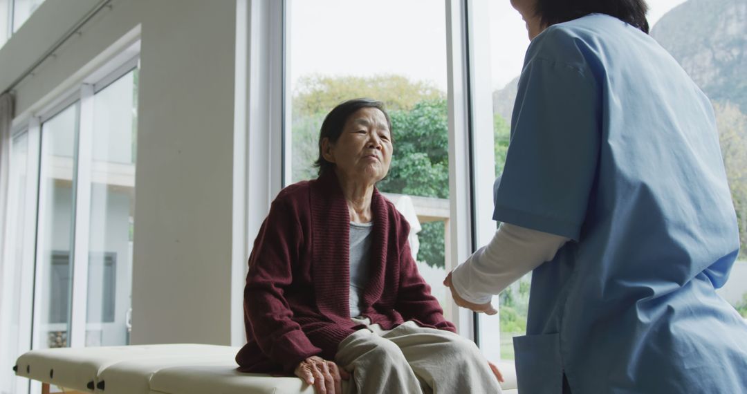 Elderly Woman Receiving Care from Nurse in Healthcare Facility - Free Images, Stock Photos and Pictures on Pikwizard.com