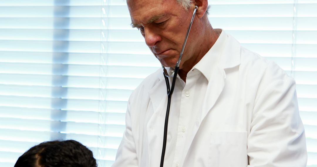 Doctor Checking Patient with Stethoscope in Medical Clinic - Free Images, Stock Photos and Pictures on Pikwizard.com