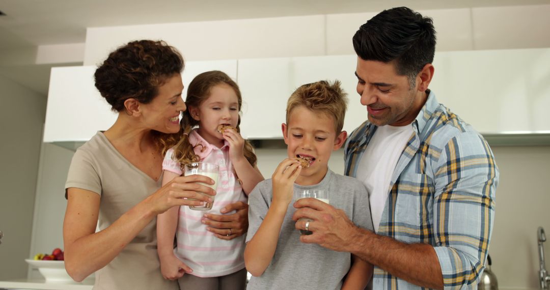 Happy Family Enjoying Snacks in Modern Kitchen - Free Images, Stock Photos and Pictures on Pikwizard.com