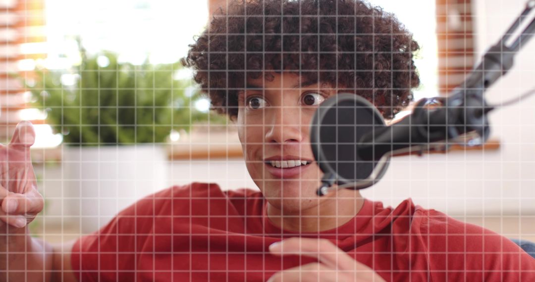 Energetic podcaster reacting to microphone in cozy home studio with grid overlay