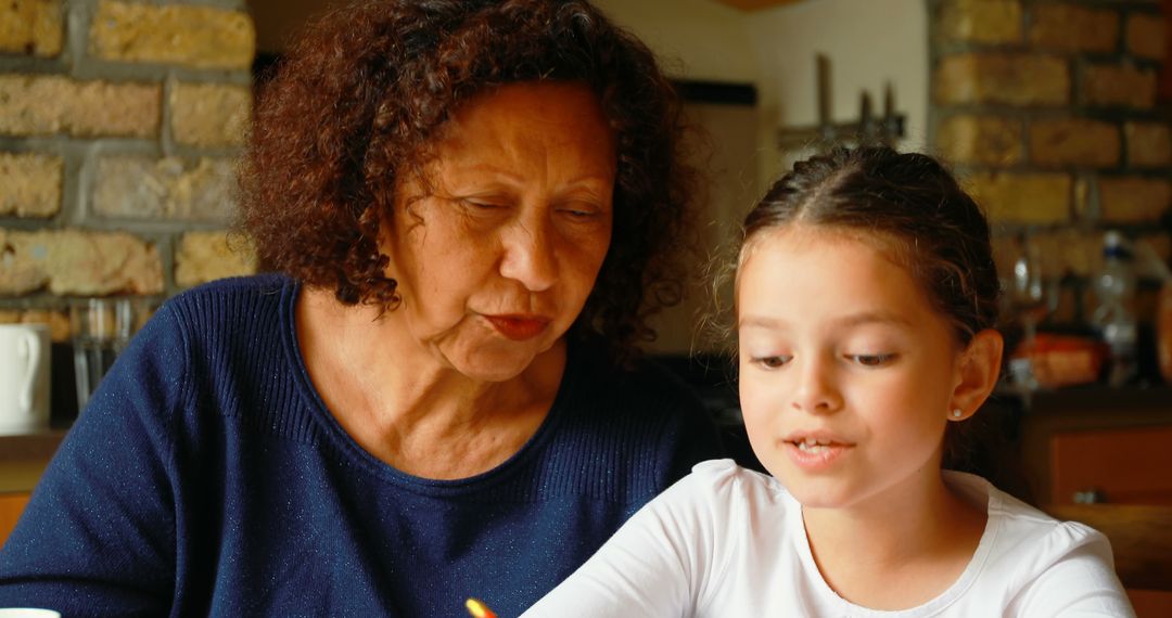 Grandmother Helping Granddaughter with Homework at Home - Free Images, Stock Photos and Pictures on Pikwizard.com