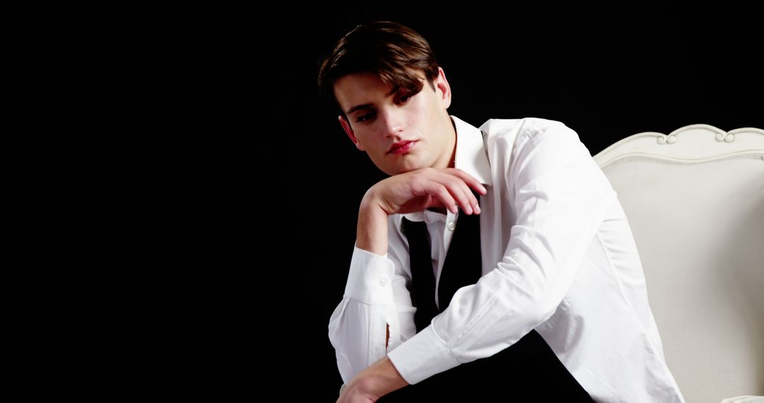 Pensive Young Man in Formal Wear with Black Background - Free Images, Stock Photos and Pictures on Pikwizard.com