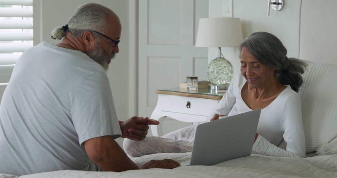 Senior Couple Enjoying Technology at Home in Bedroom - Free Images, Stock Photos and Pictures on Pikwizard.com