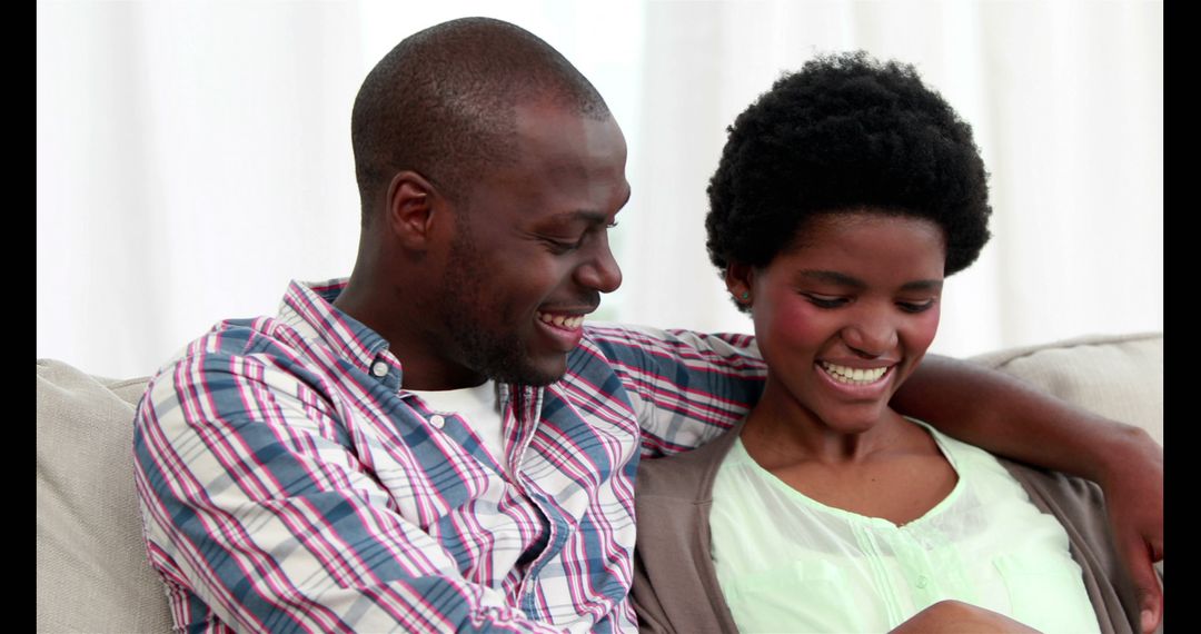 Couple on Couch Enjoying Relaxed and Happy Moment