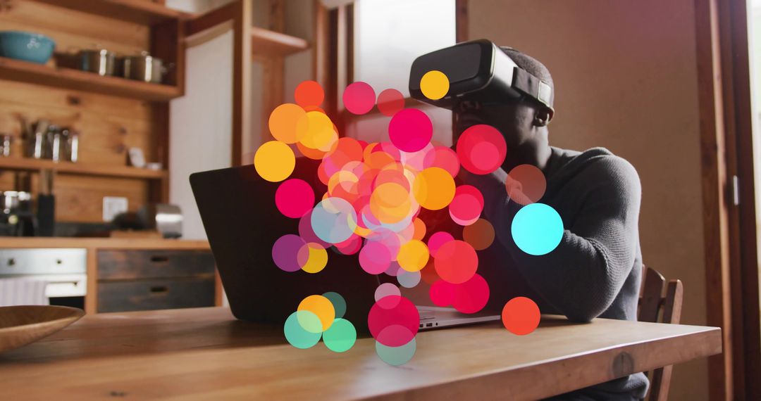 Man Using VR Headset with Laptop and Colorful Bokeh Effects