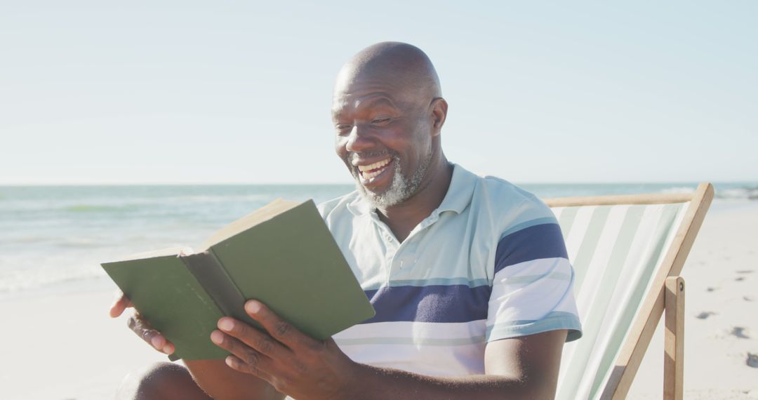 Mature Man Reading Book On Sunny Beach - Free Images, Stock Photos and Pictures on Pikwizard.com