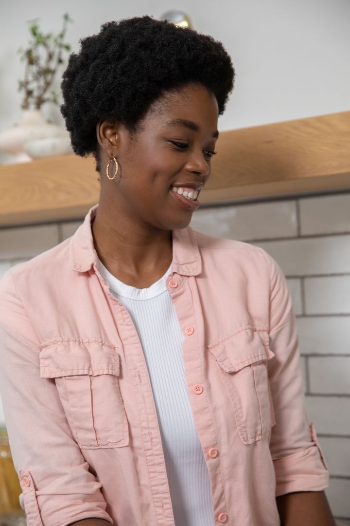 Smiling Woman Enjoying Modern Minimalist Kitchen with Decor