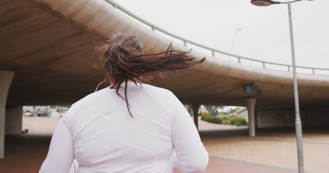 Person Jogging Outdoors Under Bridge - Free Images, Stock Photos and Pictures on Pikwizard.com